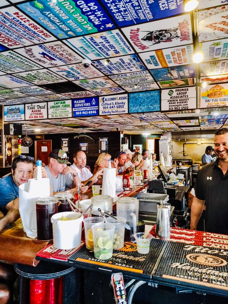 Guests at the bar under the ceiling covered in painted tiles