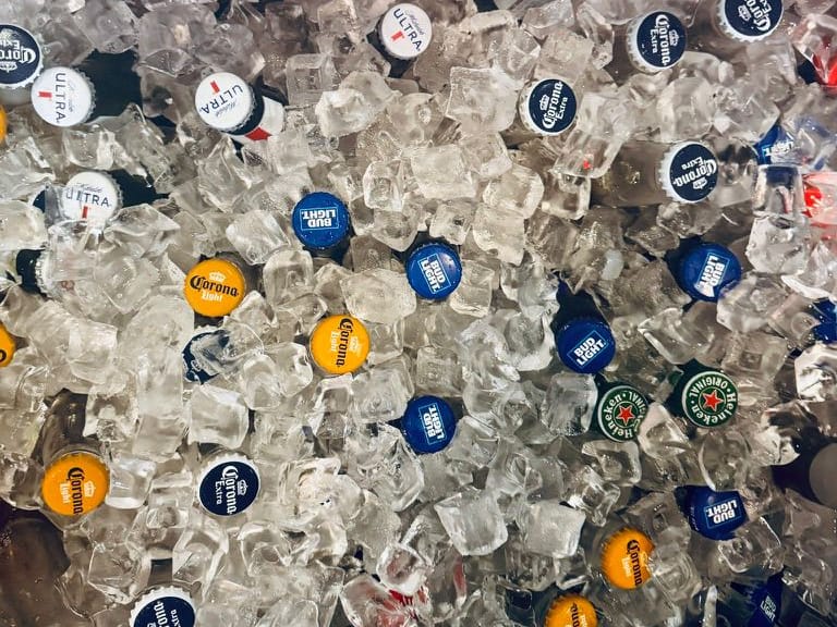 Bottles of beer chilling in a bin of ice
