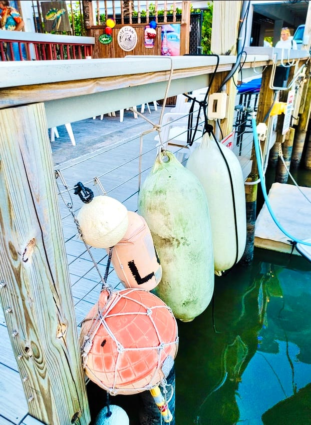 Old fishing buoys hanging from the deck railing