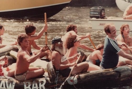 People on a raft on the water in an old photo